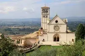 Italy Moto Tours The Basilica of Saint Francis of Assisi overlooking the Umbrian countryside, a sacred site on the Tour of Tuscany & Central Italy.
