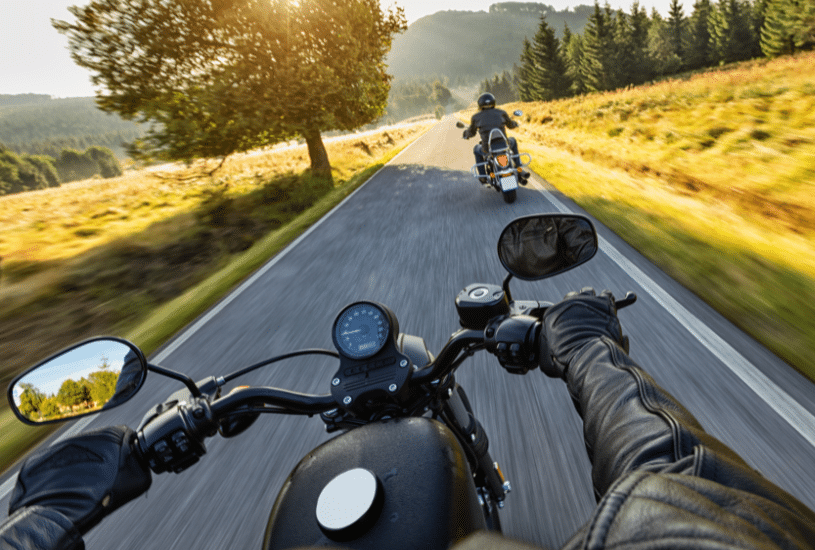 Organized motorcycle tour group riding through the scenic roads of Italy