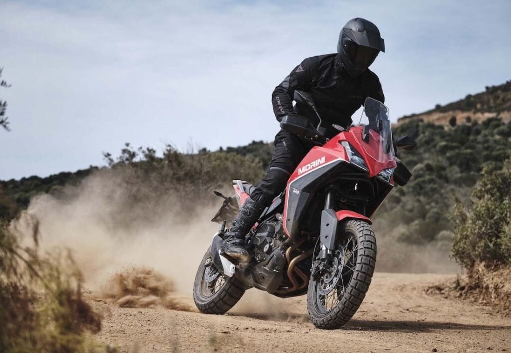 Motorcyclists conquering rugged off-road trails through Italy’s challenging terrains, kicking up dust in a thrilling adventure.