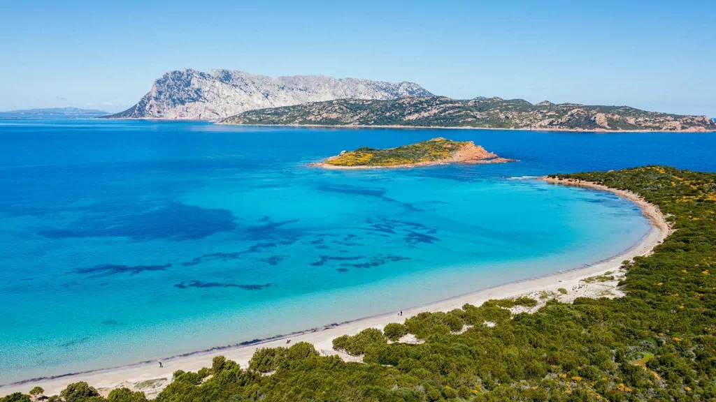 Scenic view of motorcyclists touring the rugged coastline of Sardinia on Italy Moto Tours.