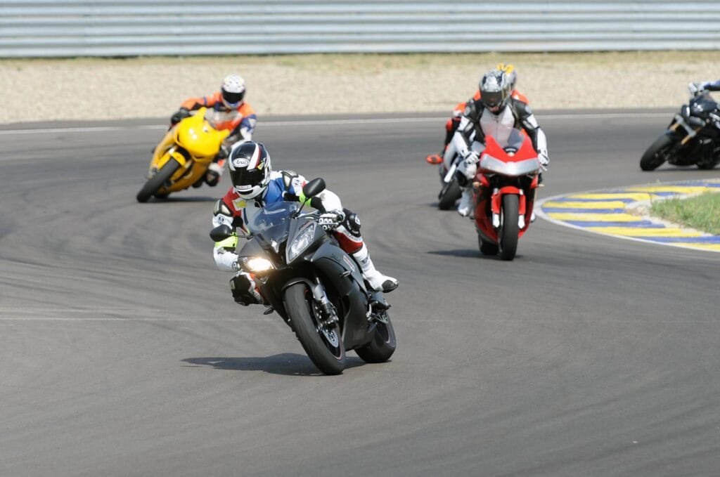 Motorcyclist speeding on a professional racing track during a track experience day in Italy, showcasing high-performance biking skills