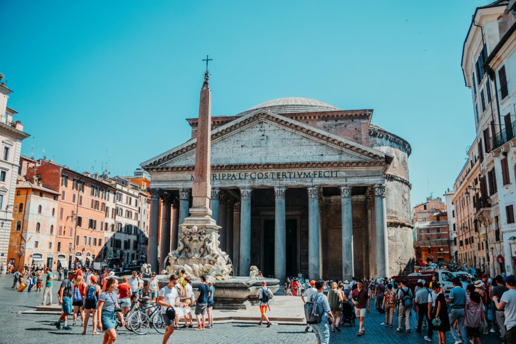 Photo of people walking in front of pantheon roman temple in rome, Italy