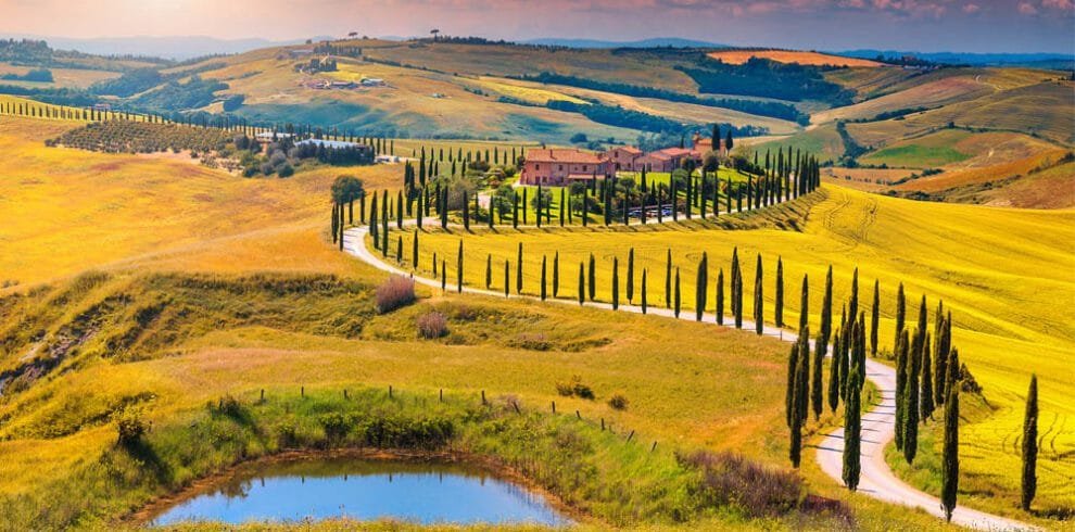 Bikers cruising through the lush vineyards and rolling hills of Tuscany, showcasing Central Italy's renowned landscapes.