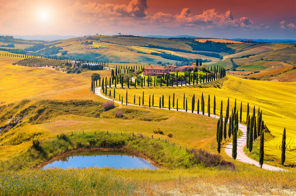 Bikers cruising through the lush vineyards and rolling hills of Tuscany, showcasing Central Italy's renowned landscapes.