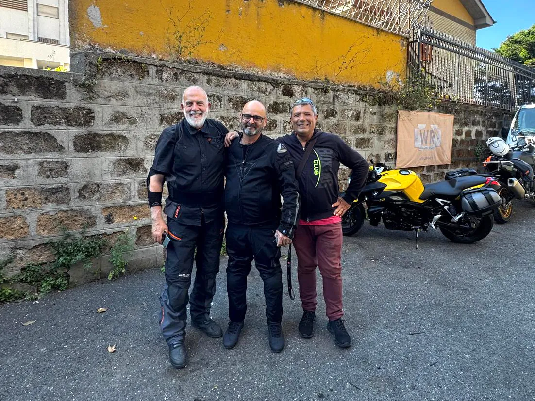 Italy Moto Tours Instructor, tour team member and business owner standing together near motorcycles during an Amalfi Coast motorcycle tour.