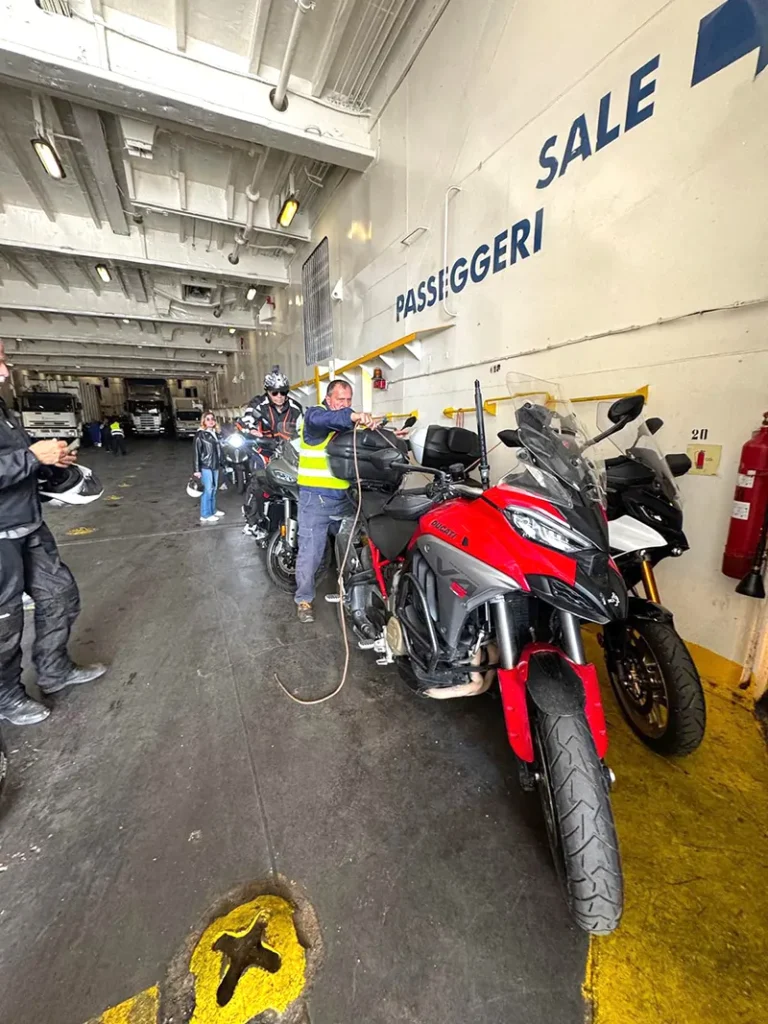 Italy Moto Tours Motorcycles being secured inside a ferry en route to Ischia Island during an Italy Moto Tours adventure along the Amalfi Coast