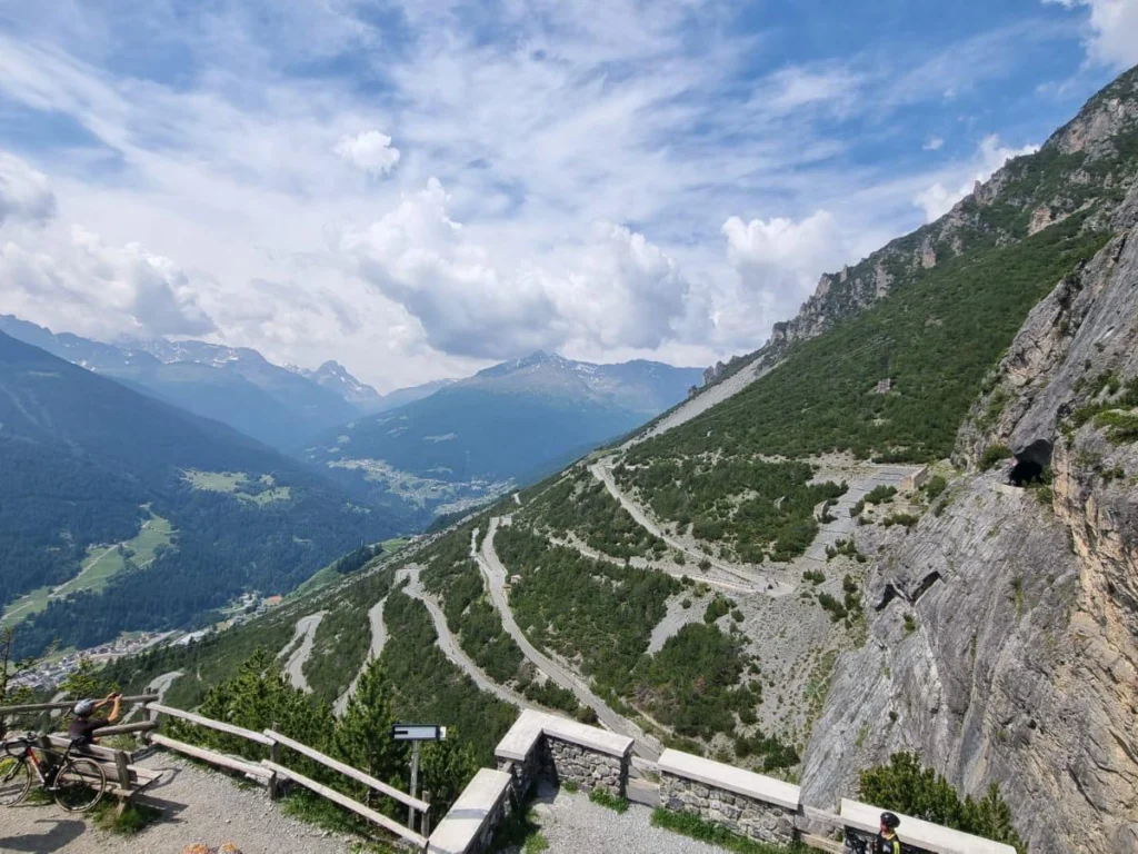 Italy Moto Tours Panoramic view of Stelvio Pass hairpin switchbacks above Bormio in the Italian Alps.