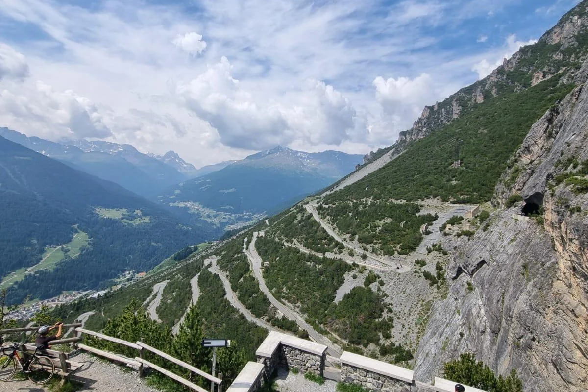 Panoramic view of Stelvio Pass hairpin switchbacks above Bormio in the Italian Alps.