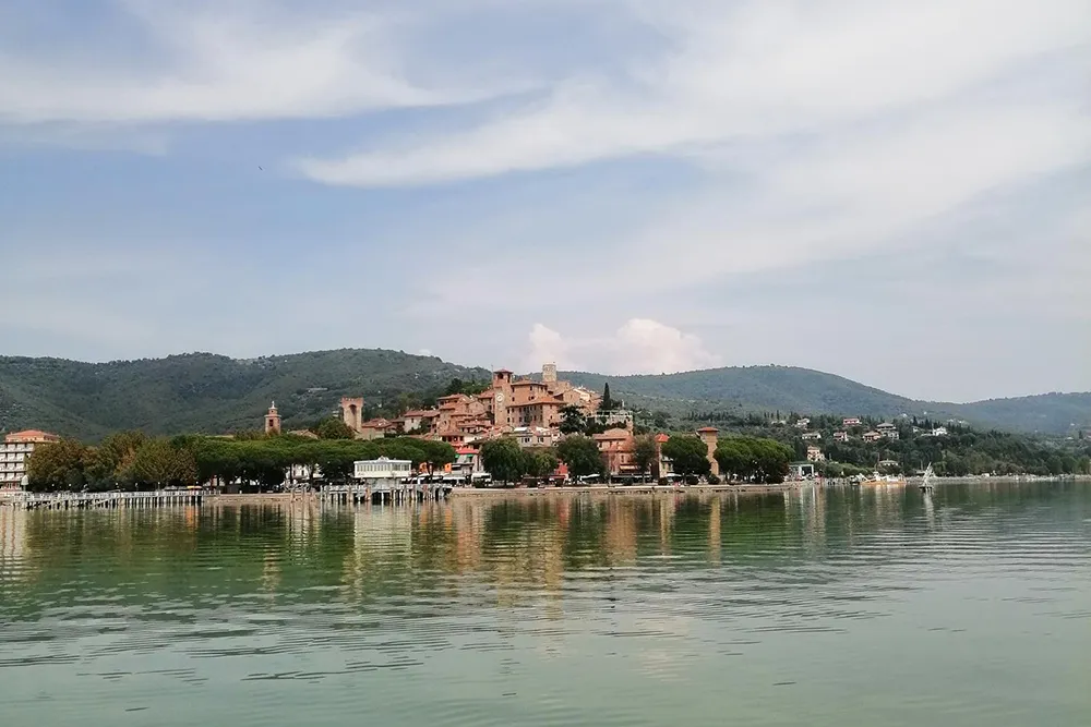 Italy Moto Tours Panorama of Passignano sul Trasimeno on Lake Trasimeno in Umbria, Italy