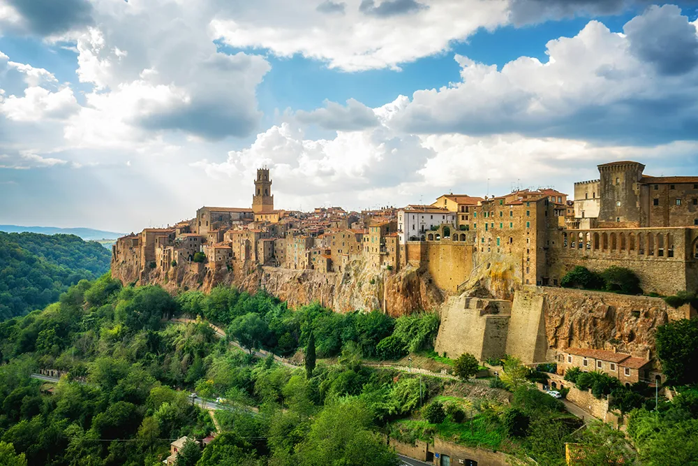 Italy Moto Tours Hill-top town of Pitigliano in the Maremma (Tuscany), built into volcanic tufa rock with green