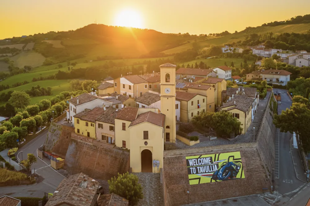 Italy Moto Tours Aerial sunset view of Tavullia with the “Welcome to Tavullia” mural in Marche, Italy