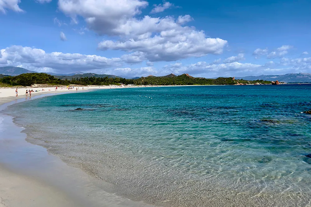 Italy Moto Tours Shallow, crystal-clear water and pale sand at Lido di Orrì beach near Tortolì on Sardinia’s east coast