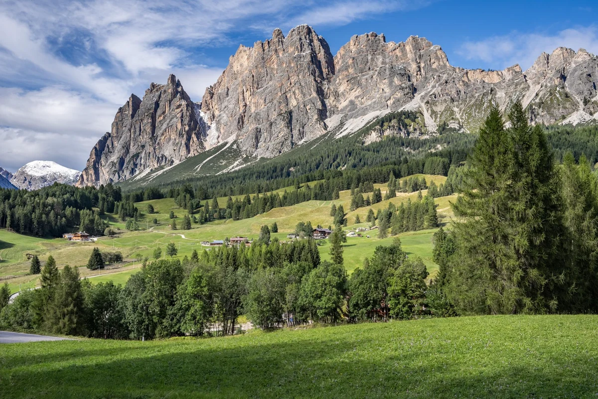 Limestone peaks and green slopes near Cortina d’Ampezzo in the Dolomites, Italy.