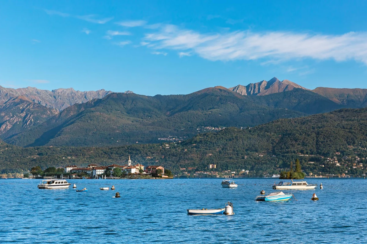 Boats on Lake Maggiore with Isola dei Pescatori and the mountains behind.