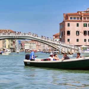 Boats on the Grand Canal beside Ponte degli Scalzi in Venice, Italy.