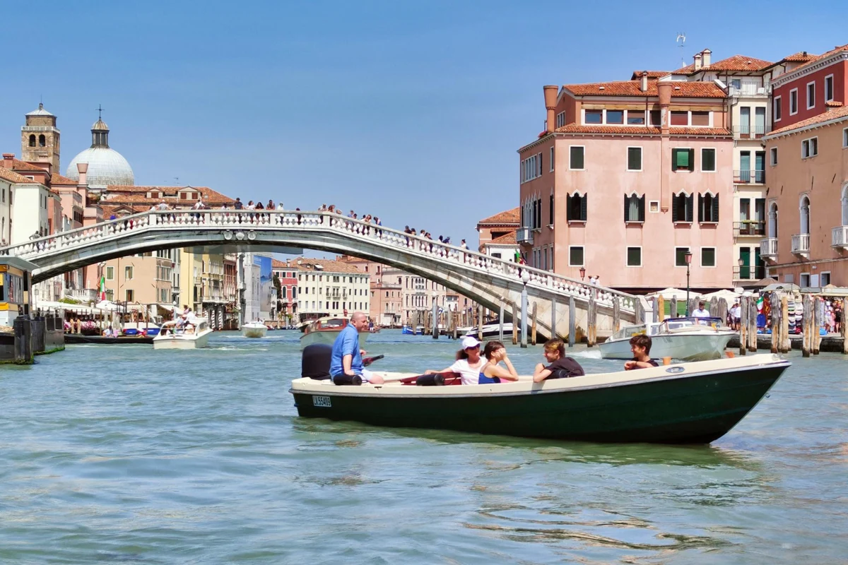 Boats on the Grand Canal beside Ponte degli Scalzi in Venice, Italy.