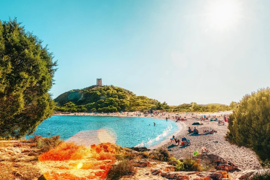 Chia beach, its coastal watchtower and turquoise Mediterranean water in southern Sardinia, Italy.